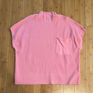 Pink oversized sweater with mock neck short sleeves and ribbed style